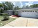 Charming single-story home with a well-maintained lawn, a two-car garage, and mature trees at 1326 Wildcat Ct, Apopka, FL 32712