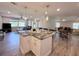 Open kitchen with an island, stainless steel appliances, and a view into the living room at 1326 Wildcat Ct, Apopka, FL 32712