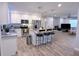 Modern eat-in kitchen with stainless steel appliances, sleek countertops, and a breakfast bar seating area at 1326 Wildcat Ct, Apopka, FL 32712