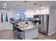 Modern kitchen with granite countertops, stainless steel appliances, and an eat-in kitchen island at 1326 Wildcat Ct, Apopka, FL 32712