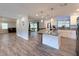 Open-concept kitchen with a marble island, stainless steel appliances, and modern pendant lighting at 1326 Wildcat Ct, Apopka, FL 32712
