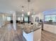 Bright kitchen featuring granite countertops, stainless sink, and views into the living and dining areas at 1326 Wildcat Ct, Apopka, FL 32712