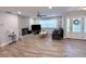 Open concept living room featuring a fireplace, wood-look flooring, and a ceiling fan at 1326 Wildcat Ct, Apopka, FL 32712