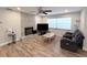 Spacious living room with a fireplace, wood-look flooring, and modern furniture at 1326 Wildcat Ct, Apopka, FL 32712