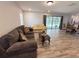 Inviting living room with comfortable seating, a coffee table, and sliding glass doors leading to the outdoors at 1326 Wildcat Ct, Apopka, FL 32712