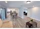 Spacious living area with wood-look flooring, modern finishes, and a seamless flow to other living spaces at 1326 Wildcat Ct, Apopka, FL 32712