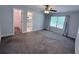 Bedroom featuring a ceiling fan, natural light, and an en-suite bathroom with walk-in closet at 1326 Wildcat Ct, Apopka, FL 32712
