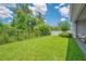 The spacious backyard with green lawn, fence, and lush trees at 14189 Larkspur Lake Dr, Winter Garden, FL 34787