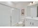 Bright bathroom featuring a glass-enclosed shower, white cabinets, and a neutral color scheme at 14189 Larkspur Lake Dr, Winter Garden, FL 34787