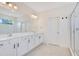 Bright bathroom featuring double sinks, white vanity, tile floors, and a glass shower at 14189 Larkspur Lake Dr, Winter Garden, FL 34787