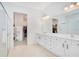 Elegant bathroom with double vanity, a large mirror, and a view of the walk-in closet at 14189 Larkspur Lake Dr, Winter Garden, FL 34787