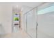 Modern bathroom with a glass-enclosed shower and a glimpse into the bedroom at 14189 Larkspur Lake Dr, Winter Garden, FL 34787