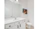 Bathroom featuring a white vanity with quartz countertop, matte black hardware and large mirror at 14189 Larkspur Lake Dr, Winter Garden, FL 34787