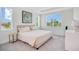 Bright bedroom with a serene vibe, featuring large windows and simple decor with a neutral palette at 14189 Larkspur Lake Dr, Winter Garden, FL 34787