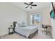 Comfortable bedroom featuring a cozy bed, window with natural light, and a modern study desk at 14189 Larkspur Lake Dr, Winter Garden, FL 34787