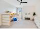 Playful bedroom with loft bed, soft carpet, bright decor, and white walls, ideal for imagination and fun at 14189 Larkspur Lake Dr, Winter Garden, FL 34787