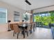 Dining room with modern lighting fixture, neutral decor, and patio access for indoor-outdoor entertaining at 14189 Larkspur Lake Dr, Winter Garden, FL 34787