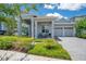 Charming home with a two-car garage, covered porch with ample seating, and paver driveway at 14189 Larkspur Lake Dr, Winter Garden, FL 34787