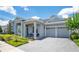 Charming home with a two-car garage, covered porch with ample seating, and paver driveway at 14189 Larkspur Lake Dr, Winter Garden, FL 34787
