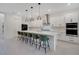Spacious kitchen features a large island with seating, white cabinets, and stainless steel appliances at 14189 Larkspur Lake Dr, Winter Garden, FL 34787
