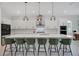 Modern kitchen featuring white cabinets, a large island with bar seating, and stainless steel appliances at 14189 Larkspur Lake Dr, Winter Garden, FL 34787