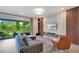 Open-concept living room offers comfortable seating, a modern entertainment center, and access to a patio at 14189 Larkspur Lake Dr, Winter Garden, FL 34787