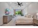 Bright main bedroom with large windows, soft natural light, a ceiling fan and plush bedding at 14189 Larkspur Lake Dr, Winter Garden, FL 34787