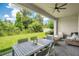 Enjoy outdoor living on this covered patio with comfortable seating and a view of the lush backyard at 14189 Larkspur Lake Dr, Winter Garden, FL 34787