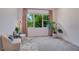 Cozy sitting area with natural light, comfortable armchairs, and view of exterior greenery at 14189 Larkspur Lake Dr, Winter Garden, FL 34787