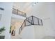 Staircase with an open concept, soaring ceilings, modern railings, and lots of natural light at 14189 Larkspur Lake Dr, Winter Garden, FL 34787