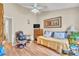 A bedroom featuring a bed, TV, wood-look floors, and a ceiling fan at 14654 Lady Victoria Blvd, Orlando, FL 32826