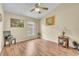 Bright bedroom features wood-look flooring, ceiling fan, and natural light from the window at 14654 Lady Victoria Blvd, Orlando, FL 32826