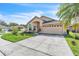 Inviting single-Gathering home boasting a well-maintained lawn, attached two-car garage, and lovely curb appeal at 14654 Lady Victoria Blvd, Orlando, FL 32826