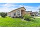 Beautiful single-Gathering home showcasing a lush green lawn and well-maintained landscaping at 14654 Lady Victoria Blvd, Orlando, FL 32826