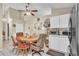 Kitchen dining area with wooden table, patterned chairs, and white cabinets providing cozy spot for meals at 14654 Lady Victoria Blvd, Orlando, FL 32826