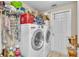 The laundry room features a side by side washer and dryer and storage at 14654 Lady Victoria Blvd, Orlando, FL 32826