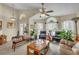 Cozy living room featuring comfortable seating, a ceiling fan, and large window for ample natural light at 14654 Lady Victoria Blvd, Orlando, FL 32826