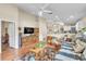 Spacious living room with open design, connecting to a kitchen bar, wooden floors, and neutral walls at 14654 Lady Victoria Blvd, Orlando, FL 32826