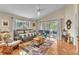 Cozy living room with tile floors, neutral paint, large windows, and sliding glass doors to screened porch at 14654 Lady Victoria Blvd, Orlando, FL 32826