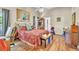 Bright bedroom with hardwood flooring, decorative floral bedding and furnishings with natural light and ceiling fan at 14654 Lady Victoria Blvd, Orlando, FL 32826