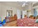 Spacious main bedroom with hardwood floors, floral-patterned bedspread, and ensuite bathroom at 14654 Lady Victoria Blvd, Orlando, FL 32826
