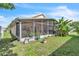 View of the backyard featuring a screened patio and lush landscaping, creating an ideal outdoor living space at 14654 Lady Victoria Blvd, Orlando, FL 32826