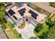 Stunning aerial view of home showcasing solar panels, tile roof, driveway, and lush landscaping at 1706 Cheltenborough Dr, Orlando, FL 32835