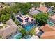 Aerial view showcasing a screened-in pool and solar panels on a two-story home in a residential area at 1706 Cheltenborough Dr, Orlando, FL 32835