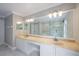 Bathroom with double vanities, large mirror, and tub shower combo at 1706 Cheltenborough Dr, Orlando, FL 32835