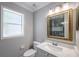 Bathroom featuring white marbled sink and shower with an ornate gold mirror at 1706 Cheltenborough Dr, Orlando, FL 32835