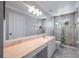 Bathroom with marble floors and counter tops and a glass door shower at 1706 Cheltenborough Dr, Orlando, FL 32835