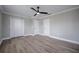This bedroom features two closets, wood-look floors, and neutral paint, creating a calming retreat at 1706 Cheltenborough Dr, Orlando, FL 32835