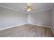 Bedroom featuring hardwood floors, neutral walls, simple ceiling fan, and a white closet door at 1706 Cheltenborough Dr, Orlando, FL 32835