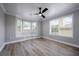 Bright bedroom features luxury vinyl flooring, a bay window with bench, and modern ceiling fan at 1706 Cheltenborough Dr, Orlando, FL 32835